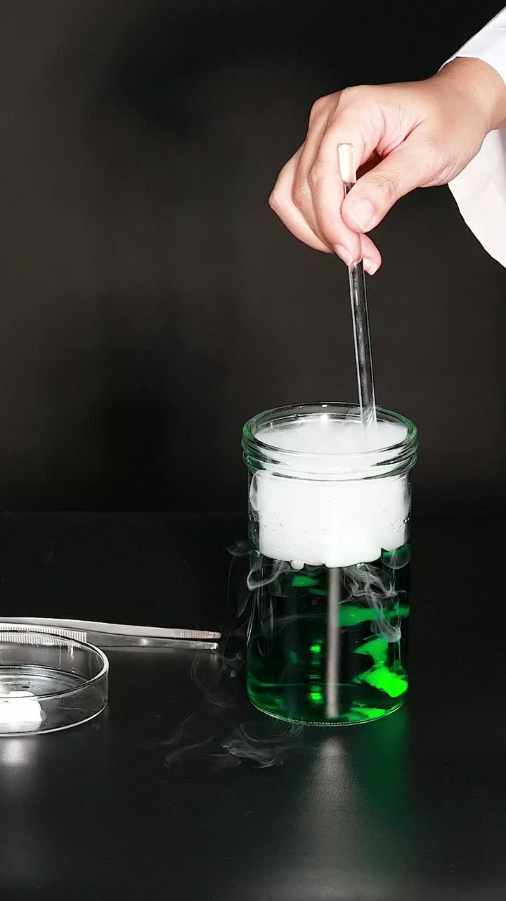 Stirring green liquid creates bubbling dry ice effect