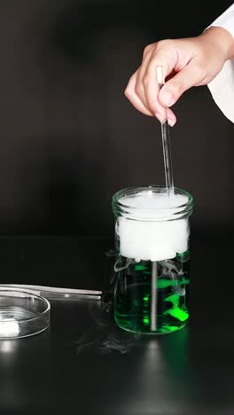 stirring green liquid creates bubbling dry ice effect