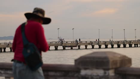 person fishing by the pier in chonburi