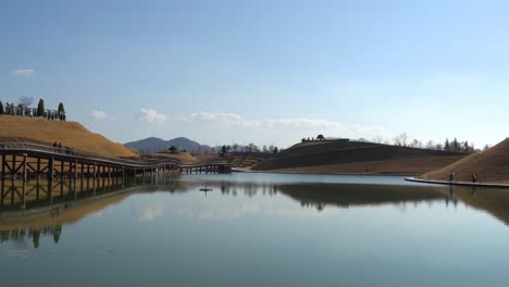 lake garden with bridge of dreams, haeryeong, bonghwa hills skyline in suncheonman bay national garden, suncheon, south korea