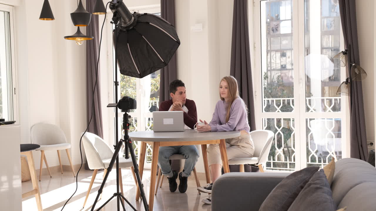 Young happy friends sharing content on streaming platform with camera - Modern marketing concept with millenial couple