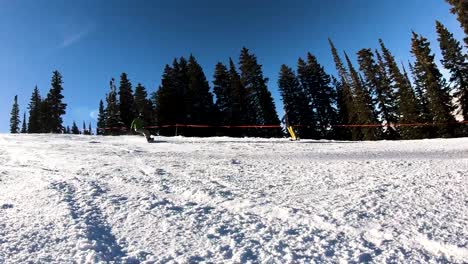 extreme slo-mo shot of a snowboarder stopping and spraying the camera with snow, completely covering the screen for a couple seconds