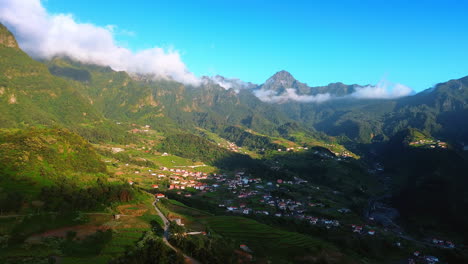 cozy town located in the picturesque valley among the high mountains. aerial perspective on the range of rocks at the madeira islands, portugal.
