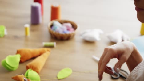 Close-up-video-of-woman-sews-handmade-carrots