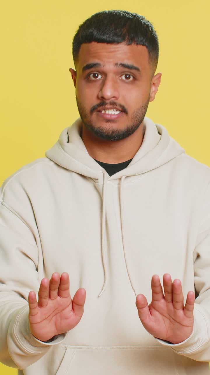 Strict indian man warning hands gesture saying no be careful advice to avoid danger caution