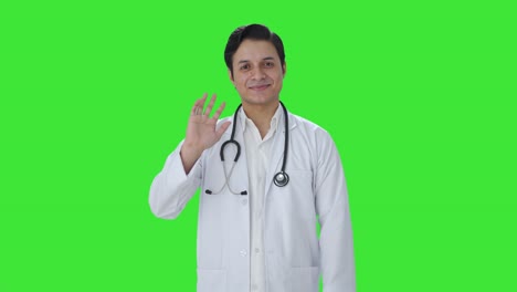 Fröhlicher-Indischer-Arzt-Sagt-Hallo,-Grüner-Bildschirm