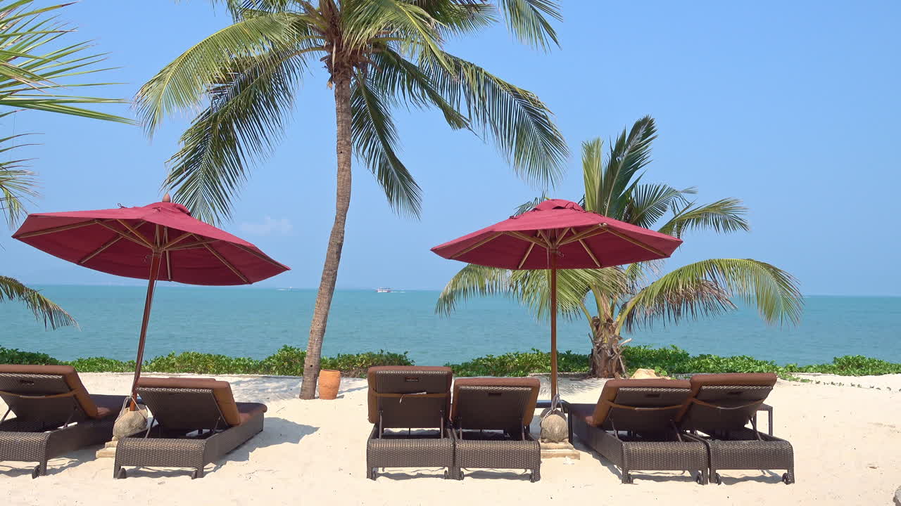 Sea front Beach lounge with red umbrellas and wooden deck chairs