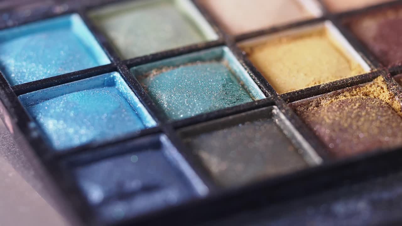 Close-up of an eyeshadow palette with brush