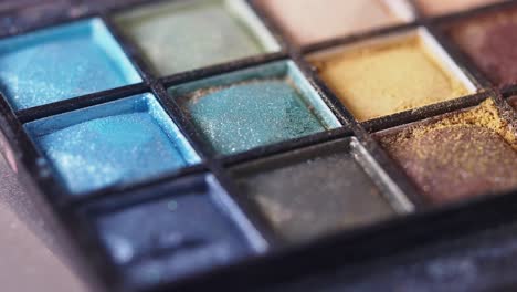 close-up of an eyeshadow palette with brush