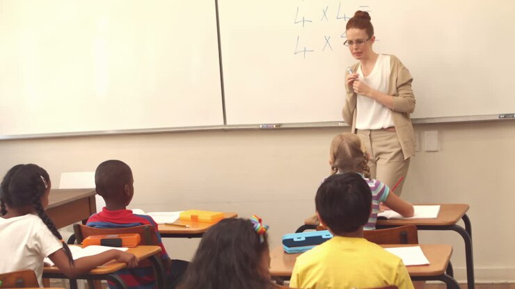 Pupils listening to their teacher at chalkboard