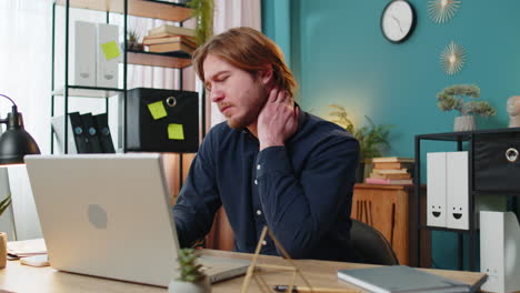 business man freelancer overworking suffers from spine neck muscle pain at home office workplace