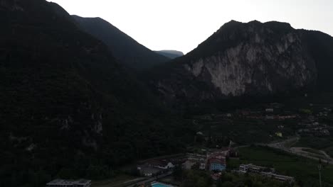 cinematic aerial drone footage of rugged italian mountains near lake garda, capturing dramatic peaks, rocky slopes, and the raw beauty of alpine terrain