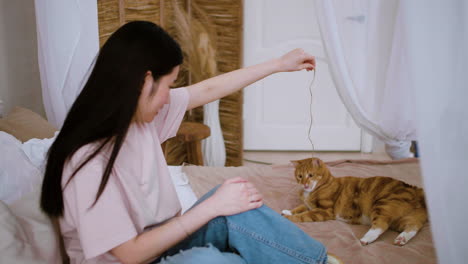 woman playing with cat