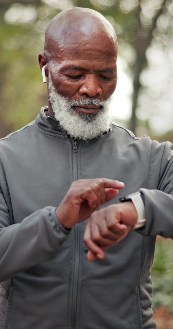 Senior Man Checking Smartwatch During Outdoor Workout