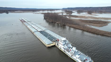 Approaching-Lansing,-Iowa,-a-towboat-pushing-barges-north-on-the-Mississippi-River-3