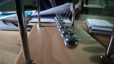 newton's cradle on a desk