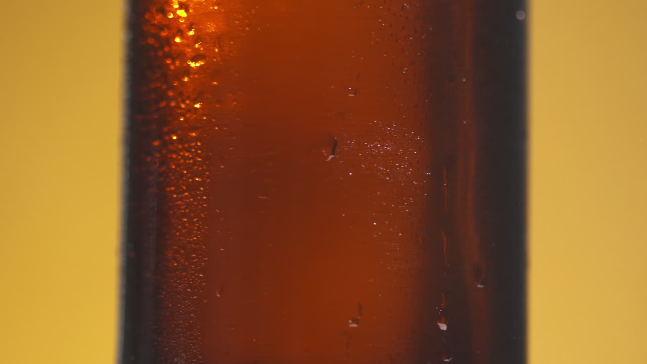 Close Up Of Condensation Droplets On Revolving Bottle Of Cold Beer Or Soft Drink With Copy Space 2