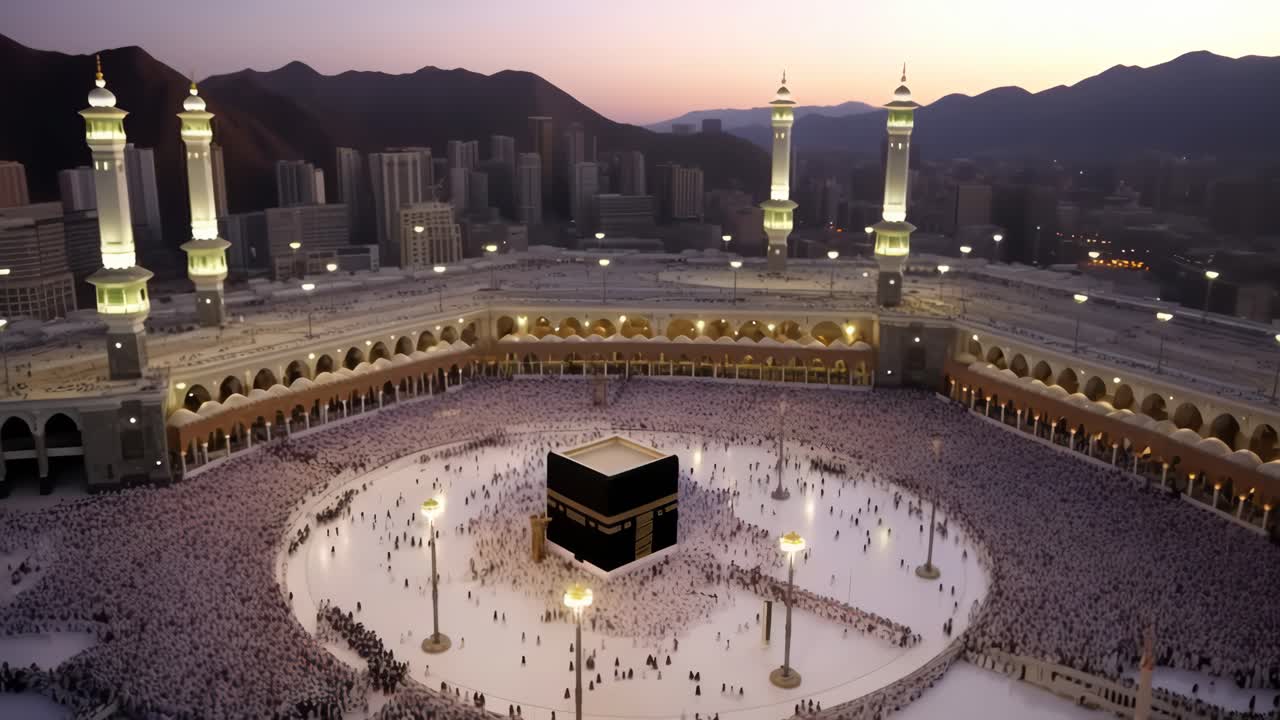 Aerial video captures the grand mosque at dusk, showcasing the Kaaba surrounded by worshippers