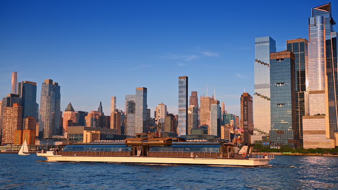 New York, USA, 4 August 2025: Hudson River ferry with Manhattan skyscrapers in background. A ferry sails along the Hudson River