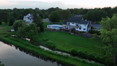spacious residential property in america, with large house, pool and expansive green lawn. surrounding trees and well-maintained landscaping showing serene suburban atmosphere. pa, usa