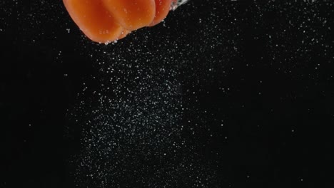 orange bell pepper falling into water