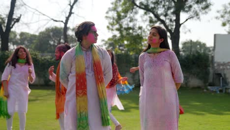 indian woman giving a gist to her husband at a holi party