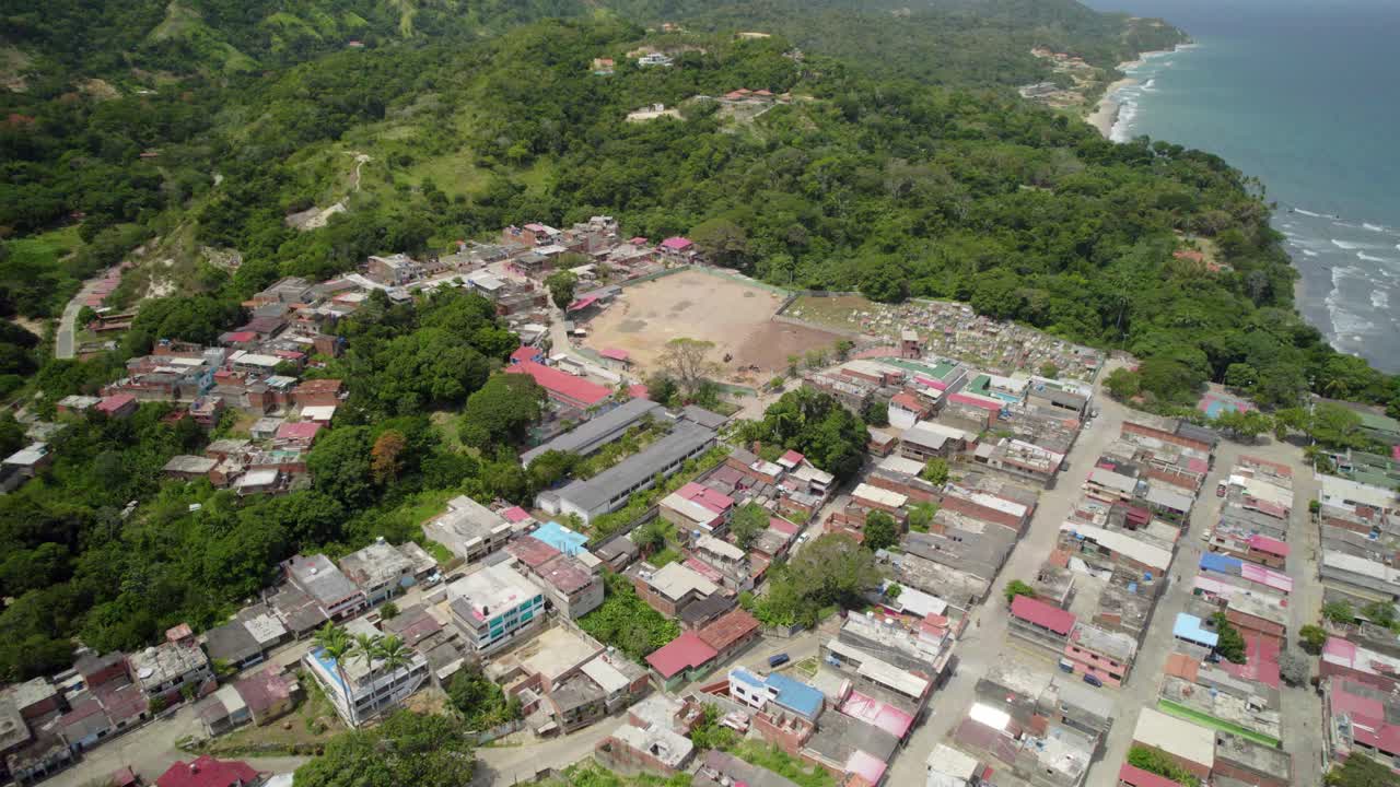 La sabana village surrounded by lush greenery and coastal landscape, aerial view