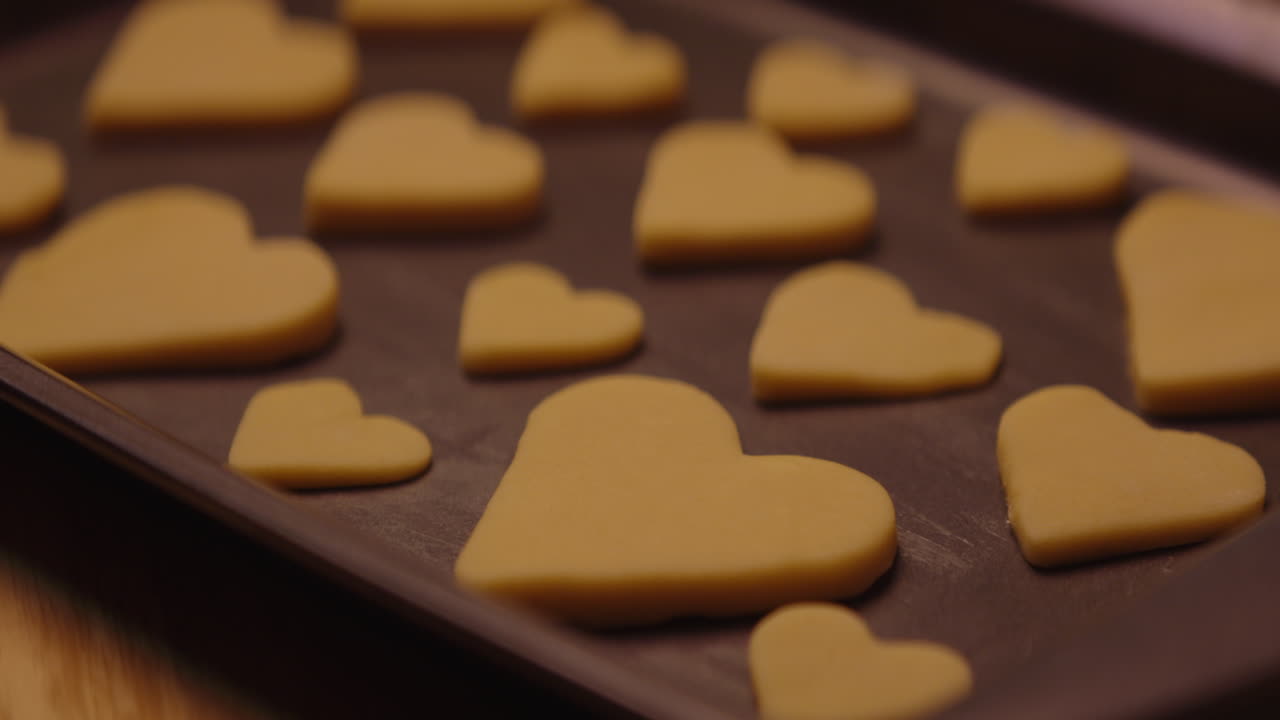 Unbaked Heart Shaped Cookies on a Baking Tray
