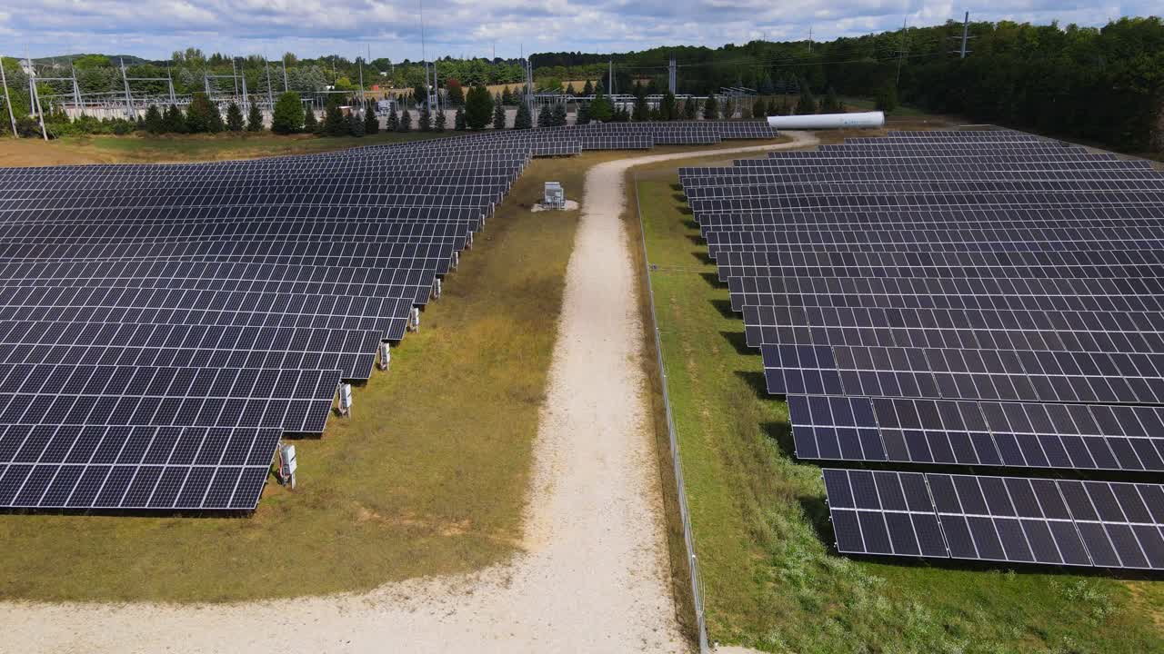 Solar panel farm field to produce electricity, aerial low altitude view