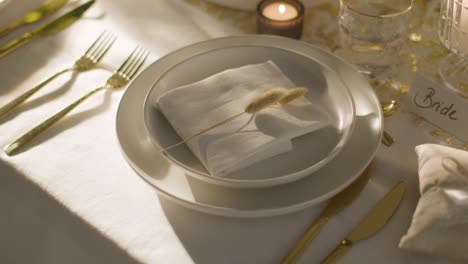 table set for meal at wedding reception with place card for bride and rings 3