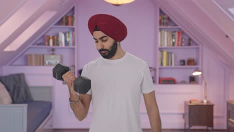 sikh indian man lifting heavy dumbbells