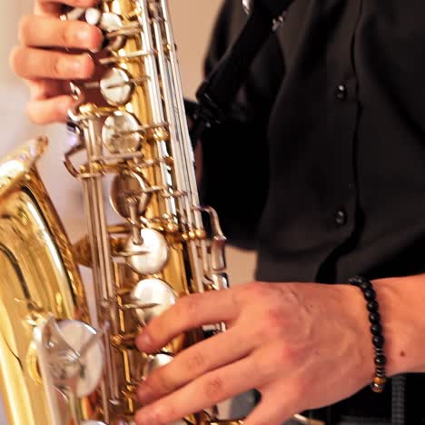 male saxophonist playing on instrument