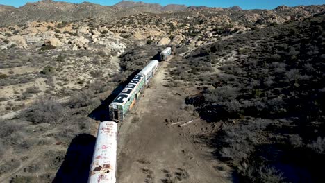 Aerial-View-of-Forgotten-Train-cars-in-Southern-California-Desert