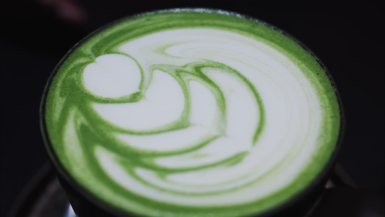 Close up of a matcha latte on a tray at a cafe