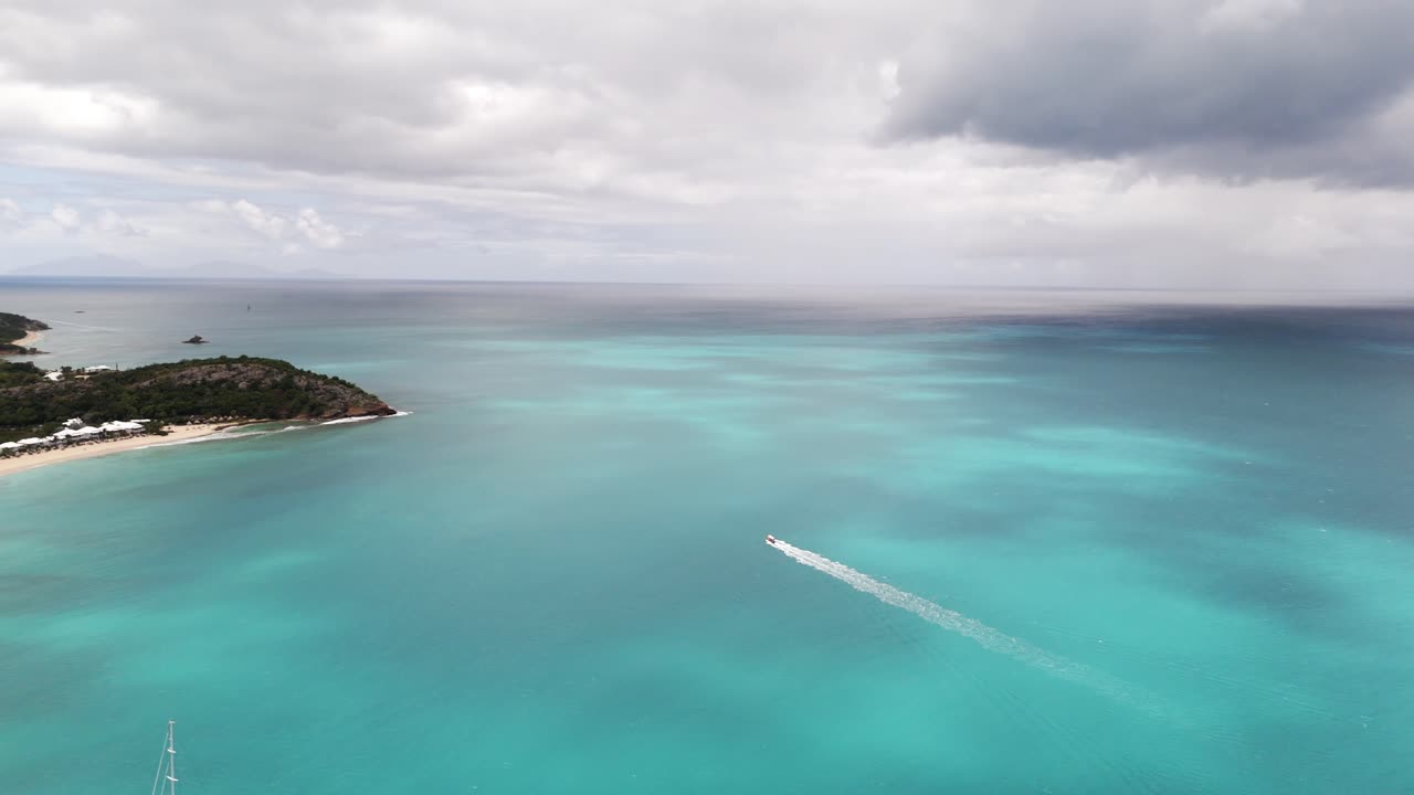 Boat Leaving Wake On Sea In Deep Bay Beach, Antigua And Barbuda - Aerial Drone Shot