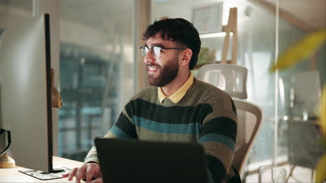 happy businessman working on his laptop at his home office desk