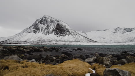 scenery of the snowcapped mountains and the ballesvika beach in senja island, norway