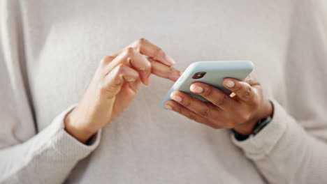 Person-holding-a-phone-while-texting-on-social