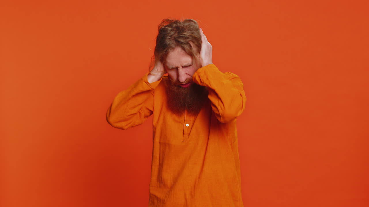 Annoyed irritated young man covering ears gesturing no avoiding advice ignoring noise loud voices