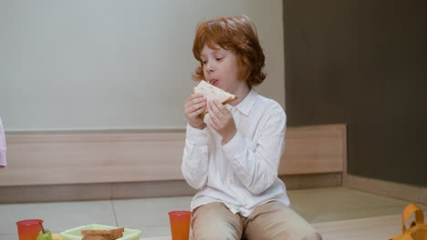 schoolboy eating.