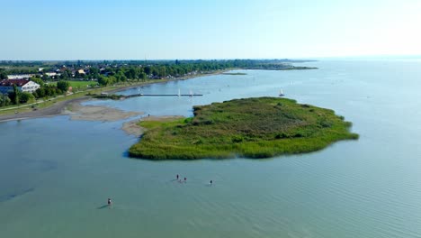 Aerial-View-Of-Green-Swamp-And-Sailing-Boats-In-Lake-Neusiedl,-Neusiedl-am-See,-Austria