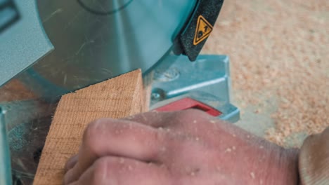 carpenter using circular saw for cutting wooden boards