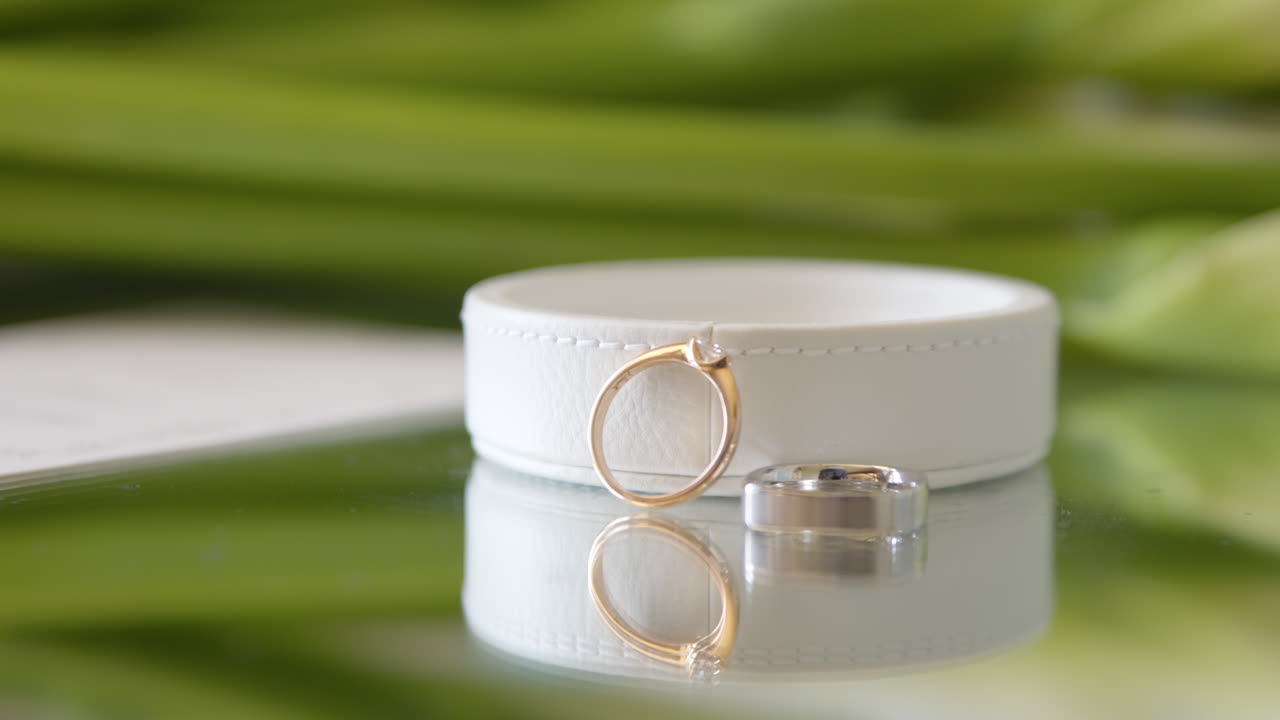 Close up rack focus on engagement rings on mirrored table