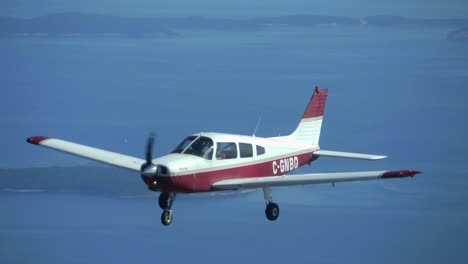 light aircraft formation flying, piper cherokee frontal view in flight