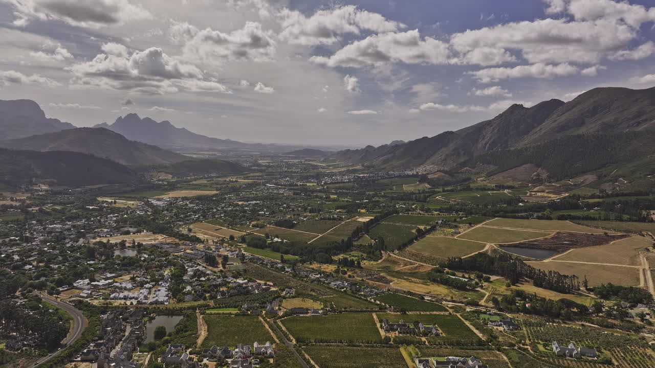 Franschhoek South Africa Aerial v13 flyover capturing picturesque panoramic views of vineyard estates, townscape, and the surrounding mountainous landscape - Shot with Mavic 3 Pro Cine - Jan 6th 2024