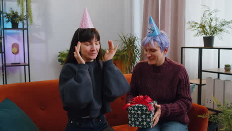 two friends celebrate a birthday with a surprise gift and joy