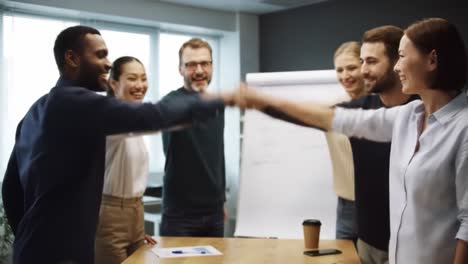 team members in a modern office gather around a table to celebrate their project completion. they share smiles and enthusiasm, emphasizing teamwork and collaboration.