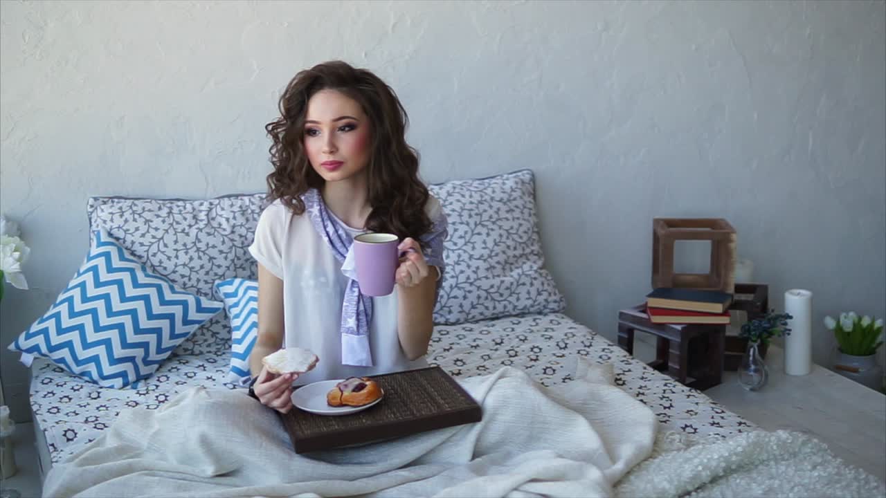 Woman Relaxing in Bed with Breakfast