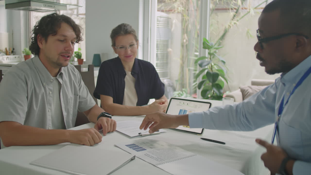 Family Couple Shaking Hands with Sales Representative in Office