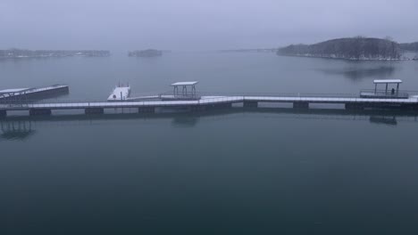 Snow-covered-piers-in-Detroit-River-International-Wildlife-Refuge-Humbug-Marsh-Unit-on-moody-winter-day-in-Detroit,-aerial-view